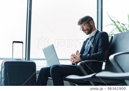 business man using his laptop during a business trip. business man using his laptop during a business trip. 96362900