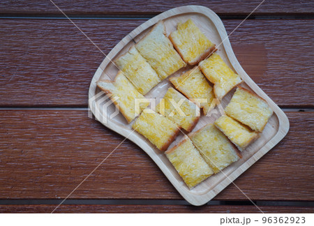 top view milk toast with sugar on wooden dish on a wooden table background, food, dessert, health, copy space top view milk toast with sugar on wooden dish on a wooden table background, food, dessert, health, copy space 96362923