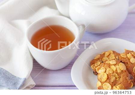 Cup of tea with cookies over lilac wooden background 96364753