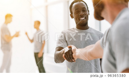 close up. successful young people shaking hands. 96365380