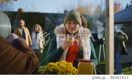 Adult woman chooses apples at the stall 96365813