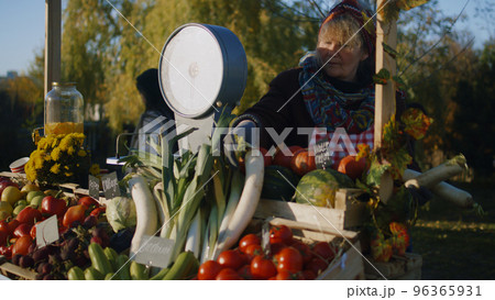 Farmer lays out fruits and vegetables Farmer lays out fruits and vegetables 96365931