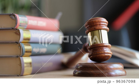 Wooden judge gavel and stack of legal book on table. Wooden judge gavel and stack of legal book on table. 96367098