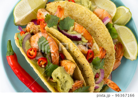 Mexican tacos wih shrimp,guacamole and vegetables isolated on white background Mexican tacos wih shrimp,guacamole and vegetables isolated on white background	 96367166