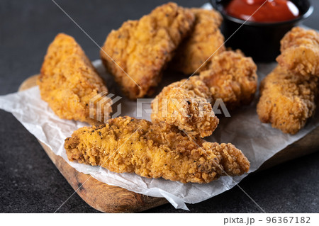Crispy Kentucky fried chicken on black slate background Crispy Kentucky fried chicken on black slate background 96367182