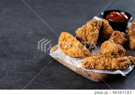 Crispy Kentucky fried chicken on black slate background Crispy Kentucky fried chicken on black slate background 96367183