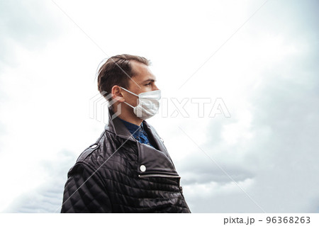 man in a protective mask against the background of a modern city man in a protective mask against the background of a modern city 96368263