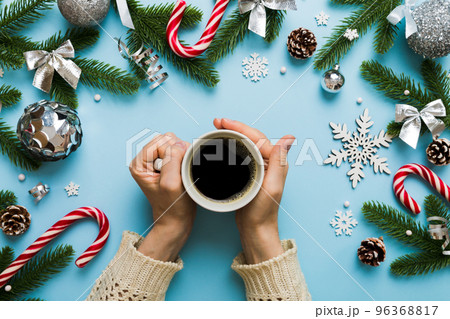 Woman holding cup of coffee. Woman hands holding a mug with hot coffee. Winter and Christmas time concept 96368817