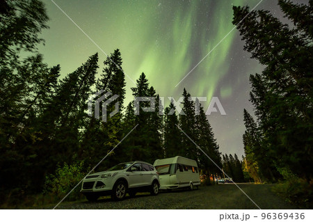 Aurora shining over Camping Caravan in Swedish forest Tannforsen Waterfall Northern Lights color sky Sweden, Scandinavia Aurora shining over Camping Caravan in Swedish forest Tannforsen Waterfall Northern Lights color sky Sweden, Scandinavia 96369436