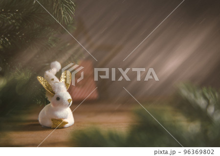 a rabbit symbol of 2023 among the lights, garlands a rabbit symbol of 2023 among the lights, garlands 96369802