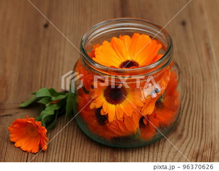 Making organic calendula oil for massage 96370626