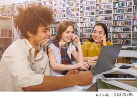 University students are studying in a library together as teamwork for preparation 96370890