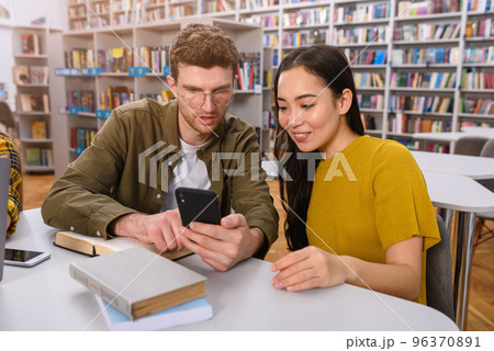 University students are studying in a library together as teamwork for preparation 96370891