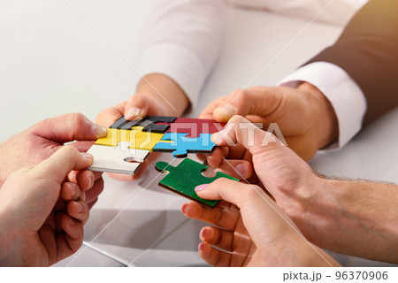 Teamwork of partners connect puzzle pieces as integration and startup 96370906