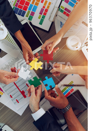 Teamwork of partners connect puzzle pieces as integration and startup Teamwork of partners connect puzzle pieces as integration and startup 96370970