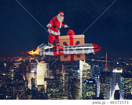 Santa claus delivers gifts with a fast space rocket Santa claus delivers gifts with a fast space rocket 96372573