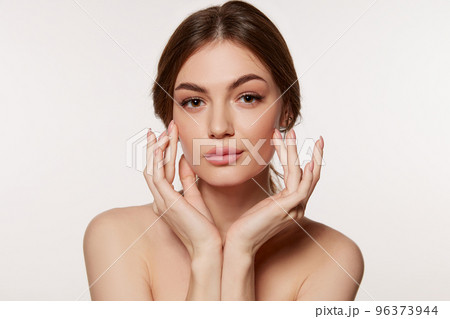 Portrait of young beautiful woman with perfect smooth skin isolated over white background. Perfect face, taking care after skin condition Portrait of young beautiful woman with perfect smooth skin isolated over white background. Perfect face, taking care after skin condition 96373944