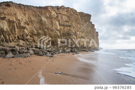 Rock formations, sandstone cliffs in West Bay beach, located near Bridport in Dorset, United Kingdom. Part of famous Jurassic coast, World Heritage Site, selective focus Rock formations, sandstone cliffs in West Bay beach, located near Bridport in Dorset, United Kingdom. Part of famous Jurassic coast, World Heritage Site, selective focus 96376285