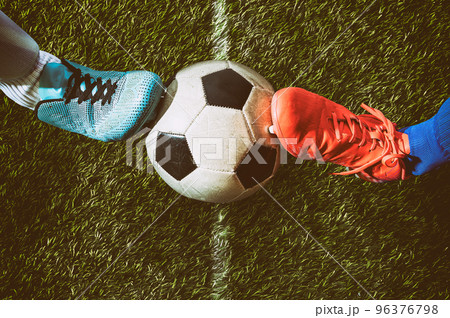 Two soccer players challenge each other at the stadium Two soccer players challenge each other at the stadium 96376798
