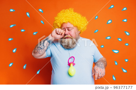 Funny man with wig act like a baby and cries for something Funny man with wig act like a baby and cries for something 96377177