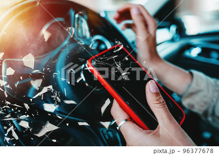 Woman drives dangerously with smartphone in hand Woman drives dangerously with smartphone in hand 96377678