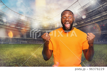 Soccer fan exults watching a football match at the stadium Soccer fan exults watching a football match at the stadium 96378229