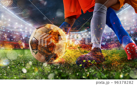 Soccer players with fiery soccerball during the match 96378282