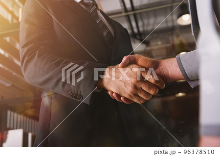 Handshaking of business person in office as teamwork and partnership Handshaking of business person in office as teamwork and partnership 96378510