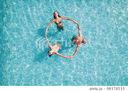 Group of friend play together in a swimming pool Group of friend play together in a swimming pool 96378533