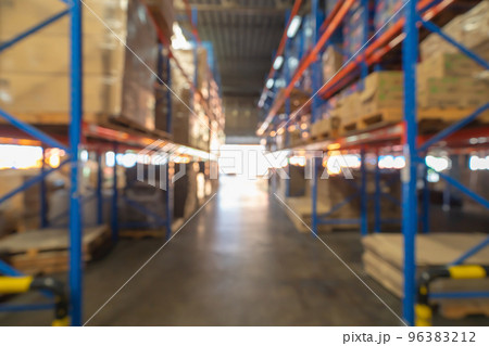 Blurry bokeh abstract background of interior of large warehouse retail store industry. Rack of furniture and home accessories stock storage. Interior of cargo in ecommerce and logistic concept. Depot 96383212