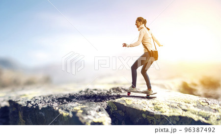Young woman riding her skateboard 96387492