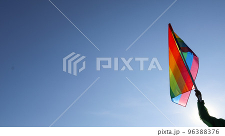 Rainbow LGBT flag waving in the bluesly background soft and selective focus copy space Rainbow LGBT flag waving in the bluesly background soft and selective focus copy space 96388376