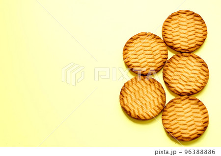 Delicious fresh cookies on a light yellow surface 96388886