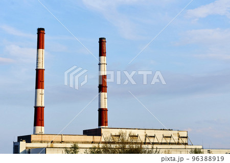 Two factory pipes of a thermal power plant against the blue sky 96388919