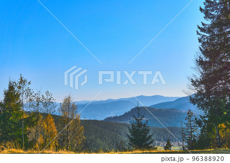 Mountain range in autumn colors and blue sky 96388920