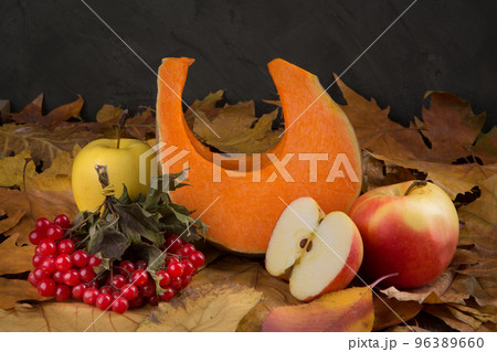 Autumn composition of a piece of pumpkin, apples and red viburnum berries, concept 96389660