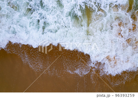 Aerial view of sea crashing waves White foaming waves on beach sand, Top view beach seascape view Nature sea ocean background Aerial view of sea crashing waves White foaming waves on beach sand, Top view beach seascape view Nature sea ocean background 96393259