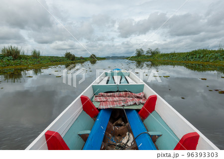 Fishing boat in a lake water in the morning,Old wooden fishing boat, wooden fishing boat in a lake water Beautiful landscape nature view in Thale noi Phatthalung Thailand 96393303