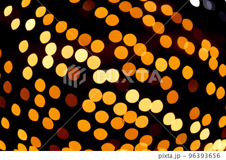 Golden defocused bokeh lights on an isolated black background. Abstract magic background with bokeh effect, golden glitter for Christmas. Overlay for your design.High quality photo 96393656