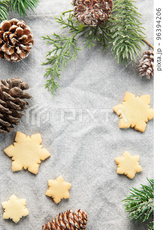 Pine branch and Christmas cookies on a textile background Pine branch and Christmas cookies on a textile background 96394206