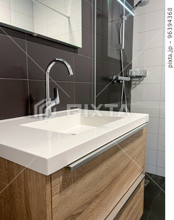 bathroom with white clean bathroom sink and shower stall bathroom with white clean bathroom sink and shower stall 96394368