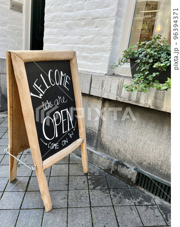open sign board in front of a shop open sign board in front of a shop 96394371