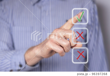 Man ticking right answer at digital screen with check mark. Businessman taking examination, survey, voting. Questionnaire, quiz. Electronic checkbox Man ticking right answer at digital screen with check mark. Businessman taking examination, survey, voting. Questionnaire, quiz. Electronic checkbox 96397268