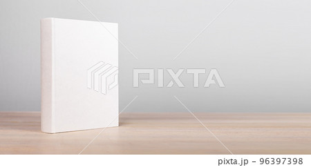 Banner with book mockup standing at wooden table. Novel, encyclopedia, code template with empty cover. Reading leisure, education, learning new information concept. Copy space 96397398