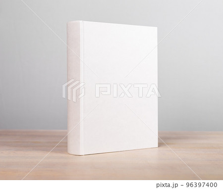 Book mockup standing at wooden table. Novel, encyclopedia, code template with blank cover. Reading leisure, education, learning new information concept 96397400