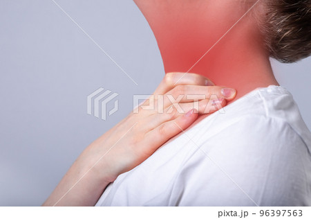 Woman suffering from sore throat. Hand touching neck with red spot closeup. Health care, illness concept. Flu, cold, inflammation. Woman suffering from sore throat. Hand touching neck with red spot closeup. Health care, illness concept. Flu, cold, inflammation. 96397563