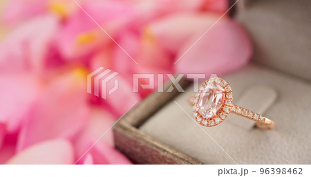 elegant wedding diamond ring in jewelry box on beautiful pink rose petal background close up elegant wedding diamond ring in jewelry box on beautiful pink rose petal background close up 96398462