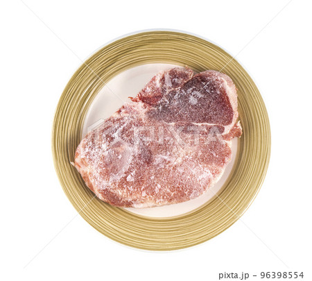 a frozen steak on a plate 96398554