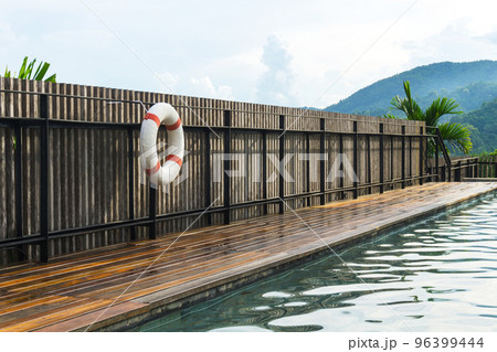 White-red lifebuoy hanging on the wall near pool in Chiang Mai, Thailand 96399444