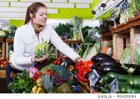 Young woman in greengrocery Young woman in greengrocery 96400084